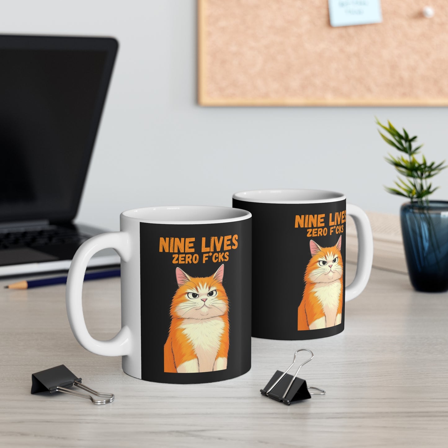Mug with a cat illustration and 11oz white ceramic mug with orange cat and text ‘Nine Lives Zero F*cks’ on black wrap design