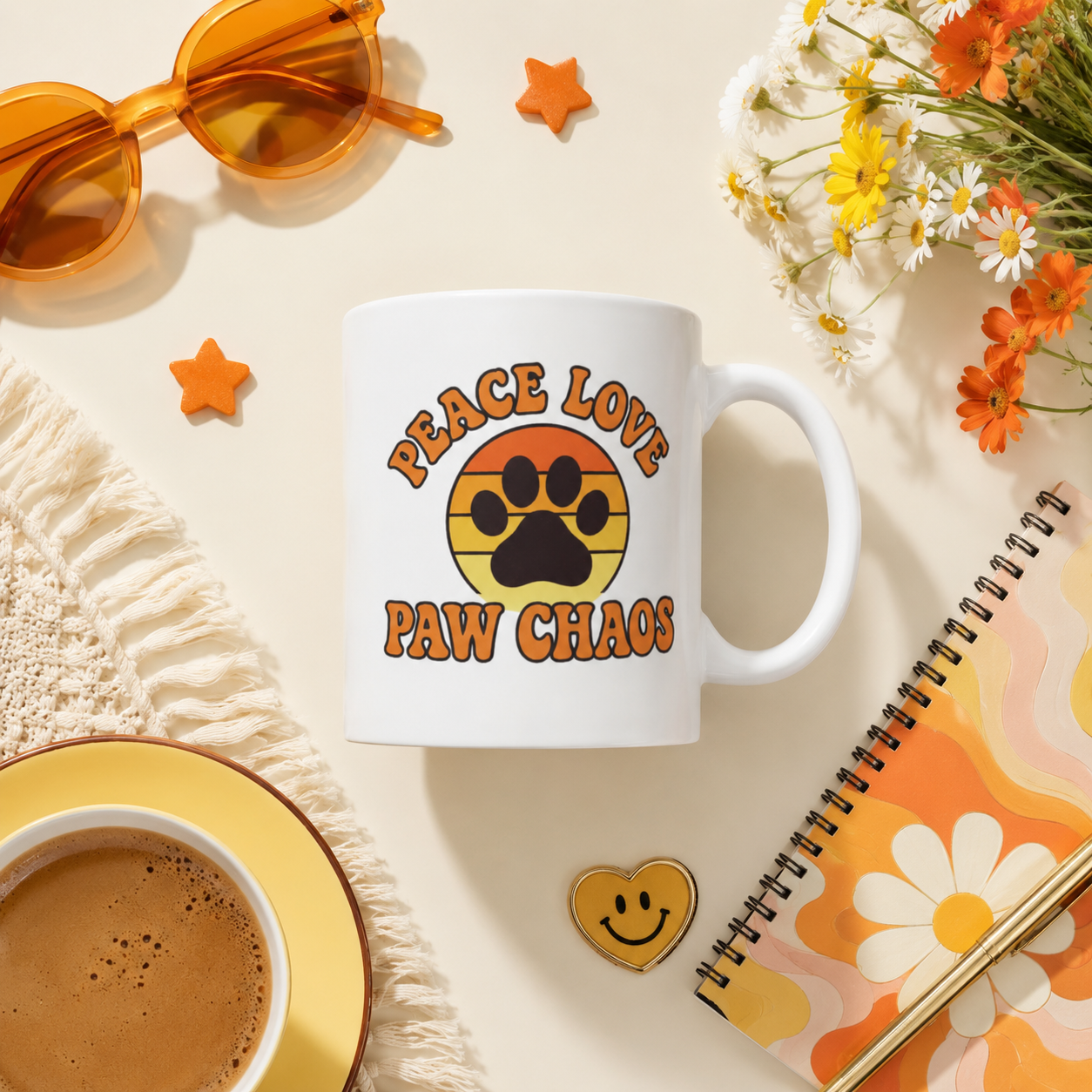 White mug with 'Peace Love Paw Chaos' design on a table with coffee, notebook, and flowers. flat view