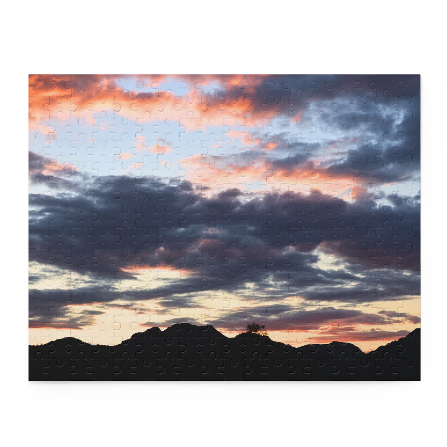 Jigsaw puzzle with Tonto sunrise scene featuring clouds and mountains.