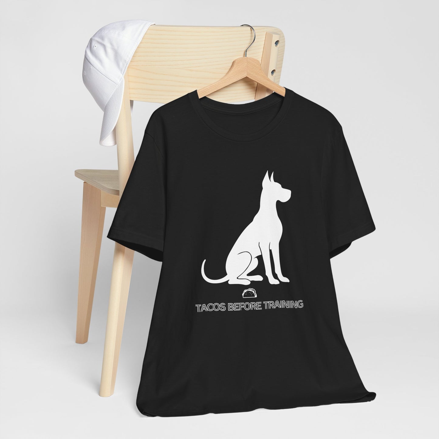 Black t-shirt with white Great Dane silhouette and text reading Tacos Before Training.