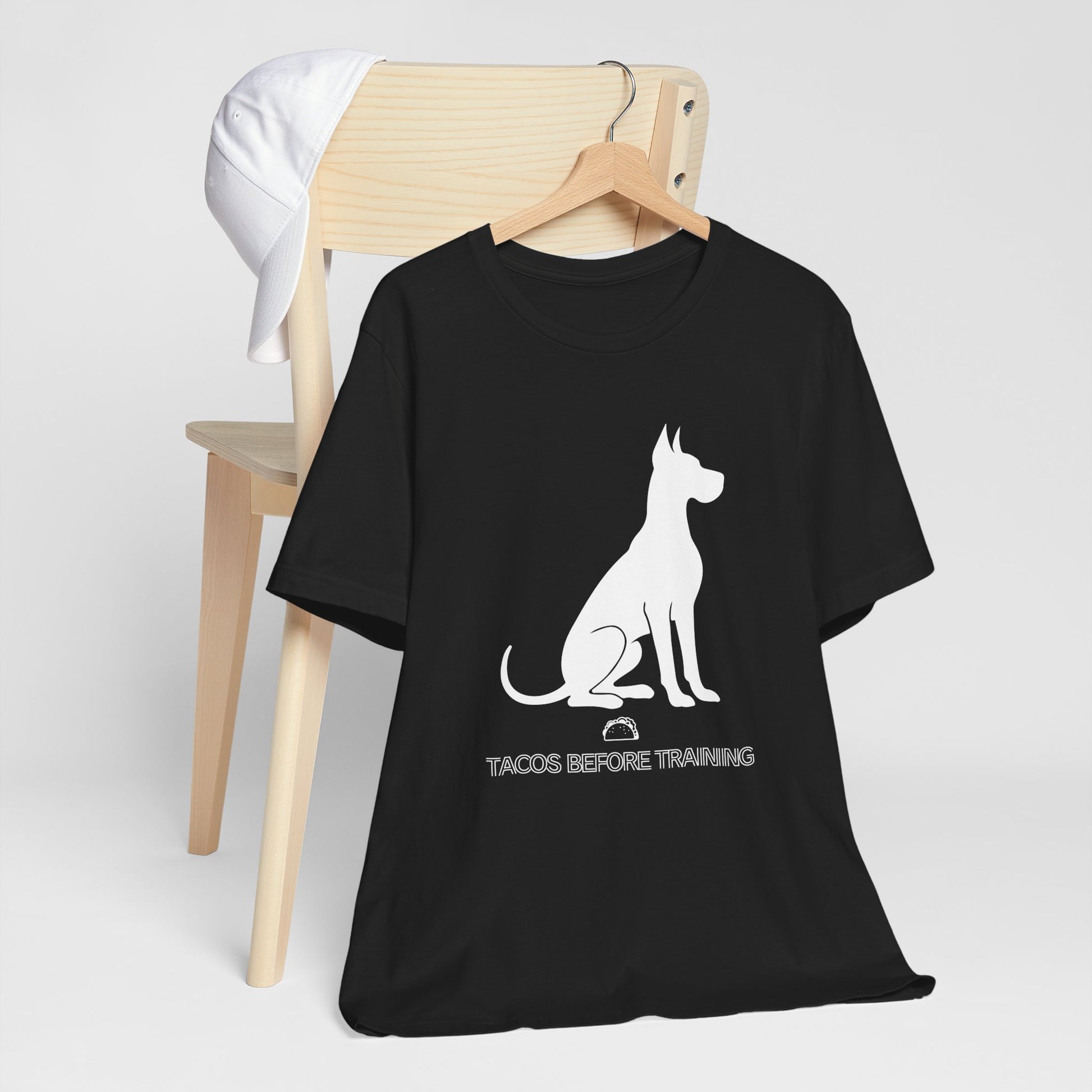 Black t-shirt with white Great Dane silhouette and text reading Tacos Before Training.