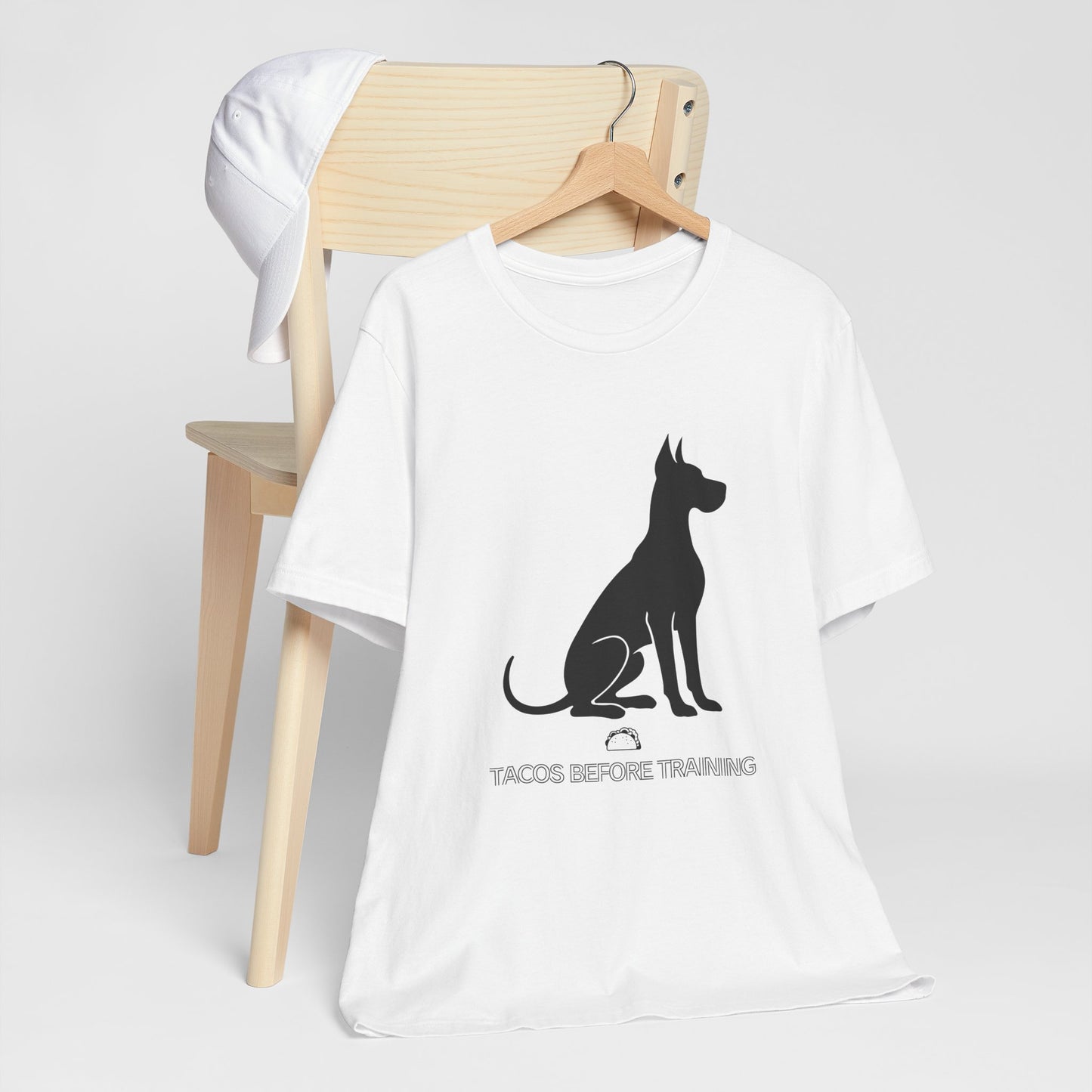 White t-shirt with white Great Dane silhouette and text reading Tacos Before Training