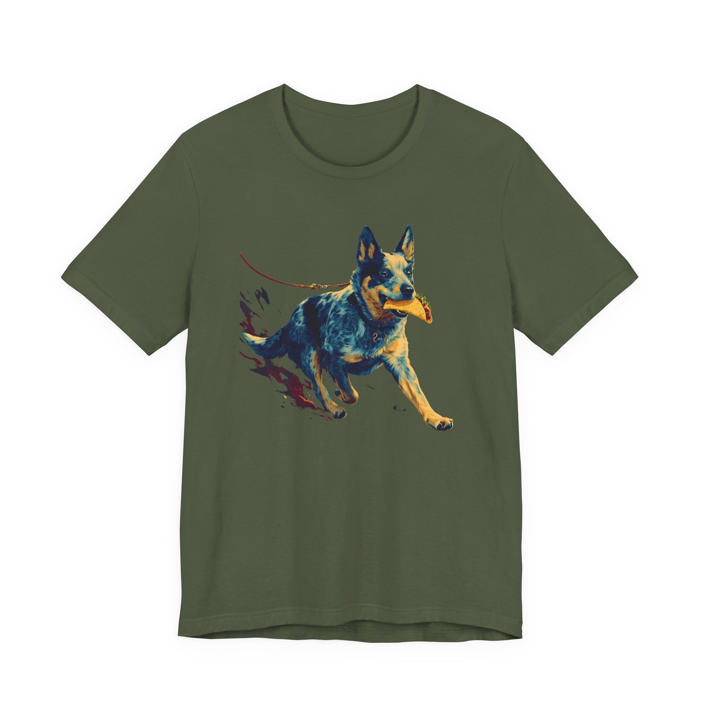 An green short-sleeve crewneck t-shirt featuring a colorful graphic print of a cattle dog running and holding a yellow ball in its mouth, displayed on a solid white background.