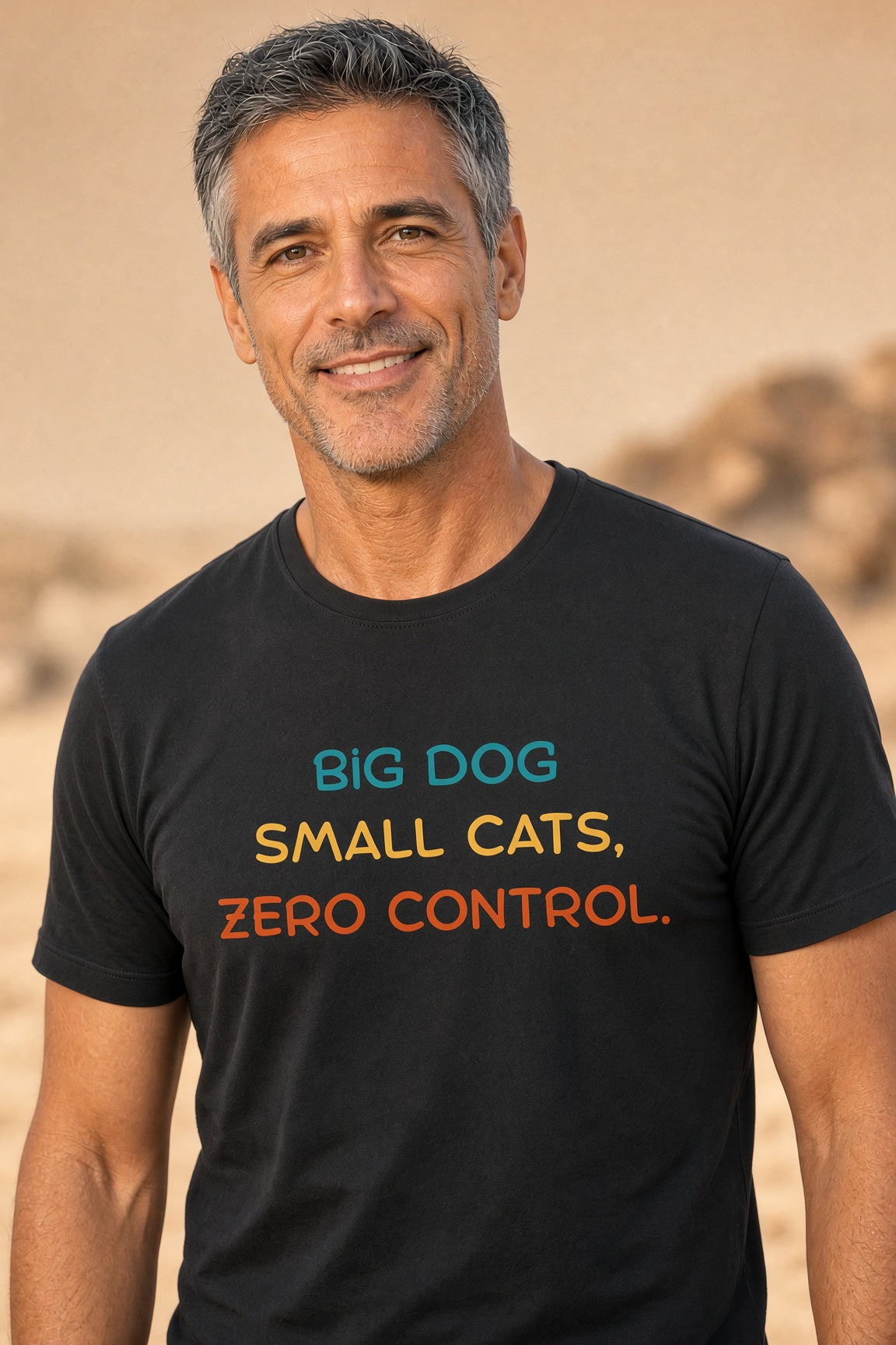 Man wearing a black t-shirt with colorful text: 'BIG DOG SMALL CATS, ZERO CONTROL.'