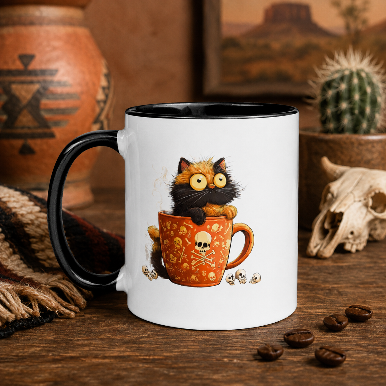 A white ceramic mug with a black handle and black interior, featuring a cartoon cat sitting in an orange mug with skull motifs. The mug is styled on a rustic wooden table with coffee beans, a cactus, a pottery vessel, and a skull in the background.
Digitally created lifestyle mockup