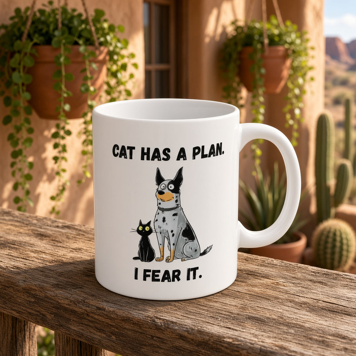 White mug with a dog and cat illustration and 'CAT HAS A PLAN. I FEAR IT.' text on a rustic wooden surface.