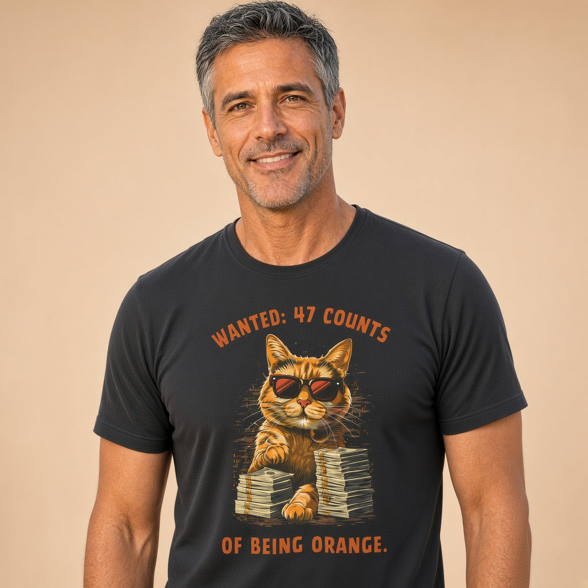 Man wearing a black t-shirt featuring a cat with sunglasses and the text 'Wanted: 47 Counts of Being Orange.'