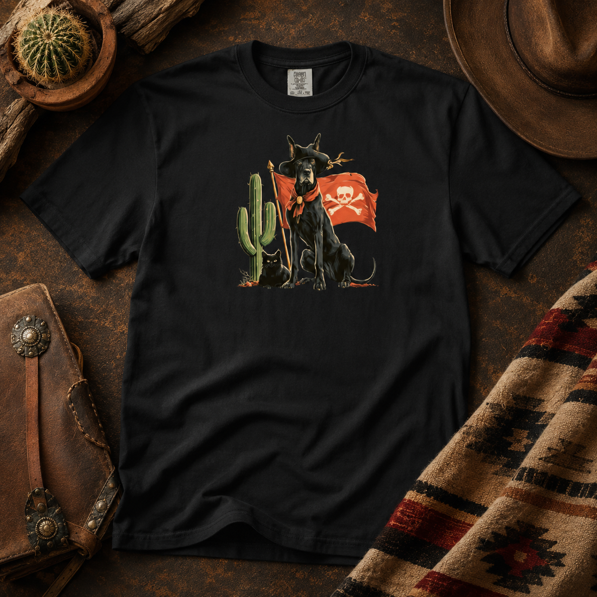Close-up of a black t-shirt with a dog and cactus design on a rustic background.