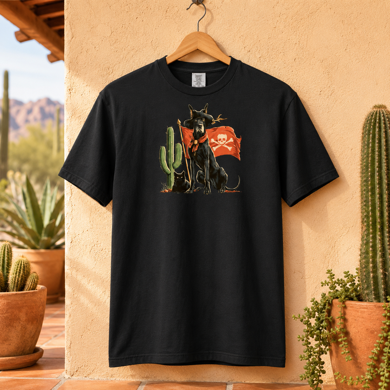 Black t-shirt featuring a dog and cactus design hanging on a wall outdoors.