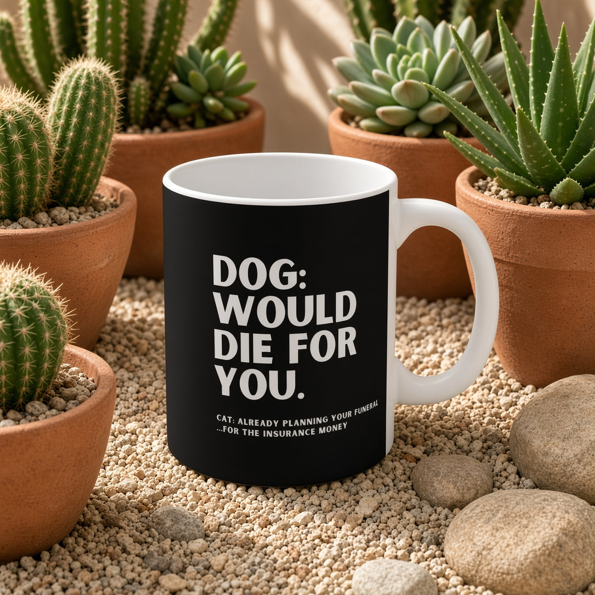 Black coffee mug surrounded by potted plants and stones