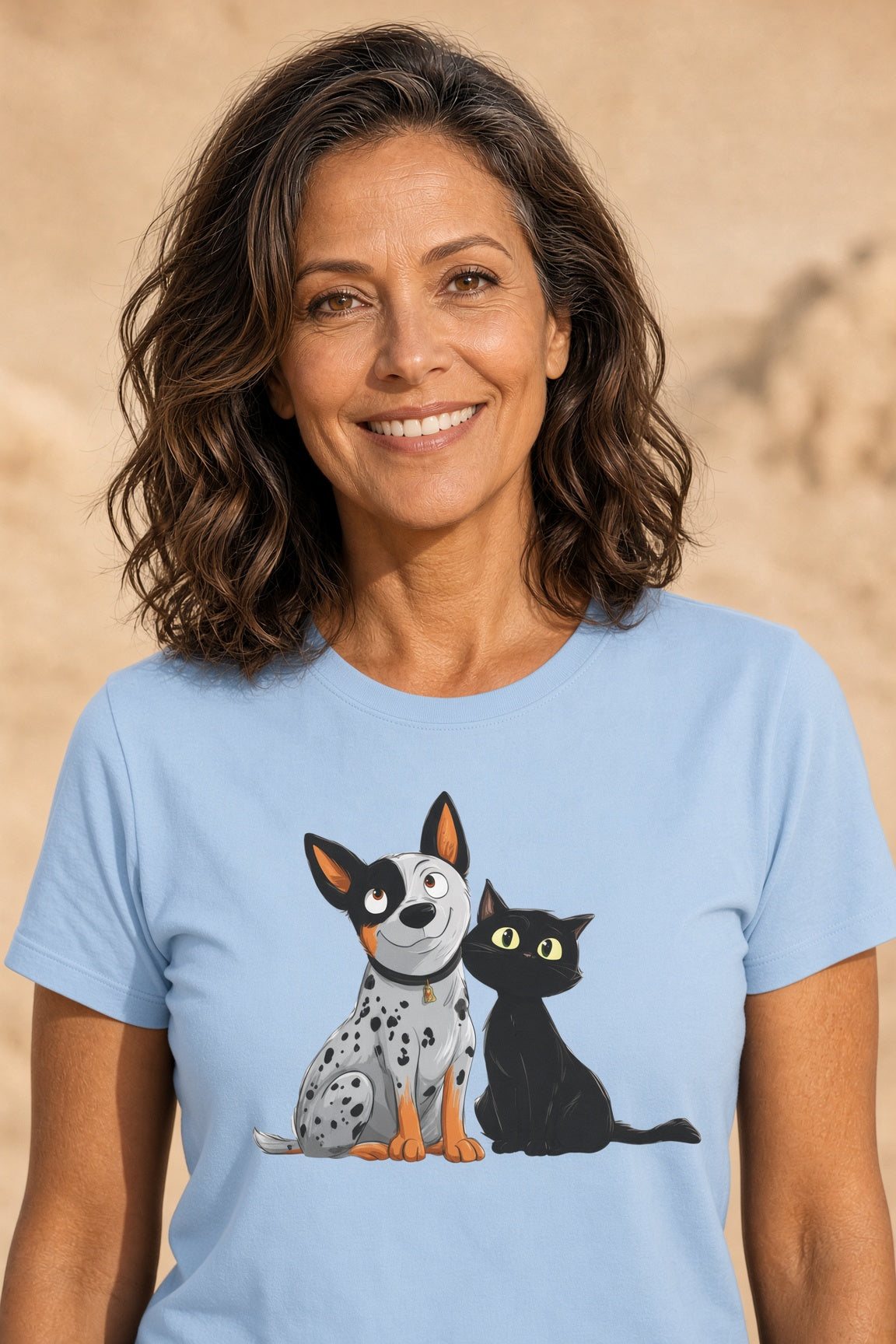 Woman smiling while wearing a light blue tee with a cattle dog and black cat illustration