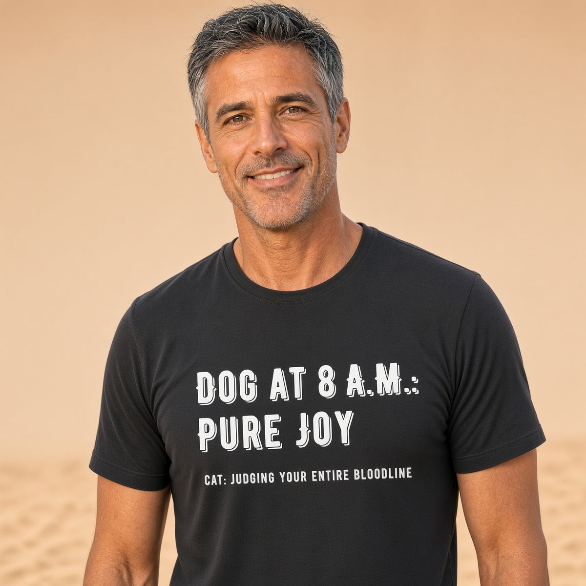 Man wearing a black t-shirt with the text 'DOG AT 8 A.M.: PURE JOY' and 'CAT: JUDGING YOUR ENTIRE BLOODLINE'