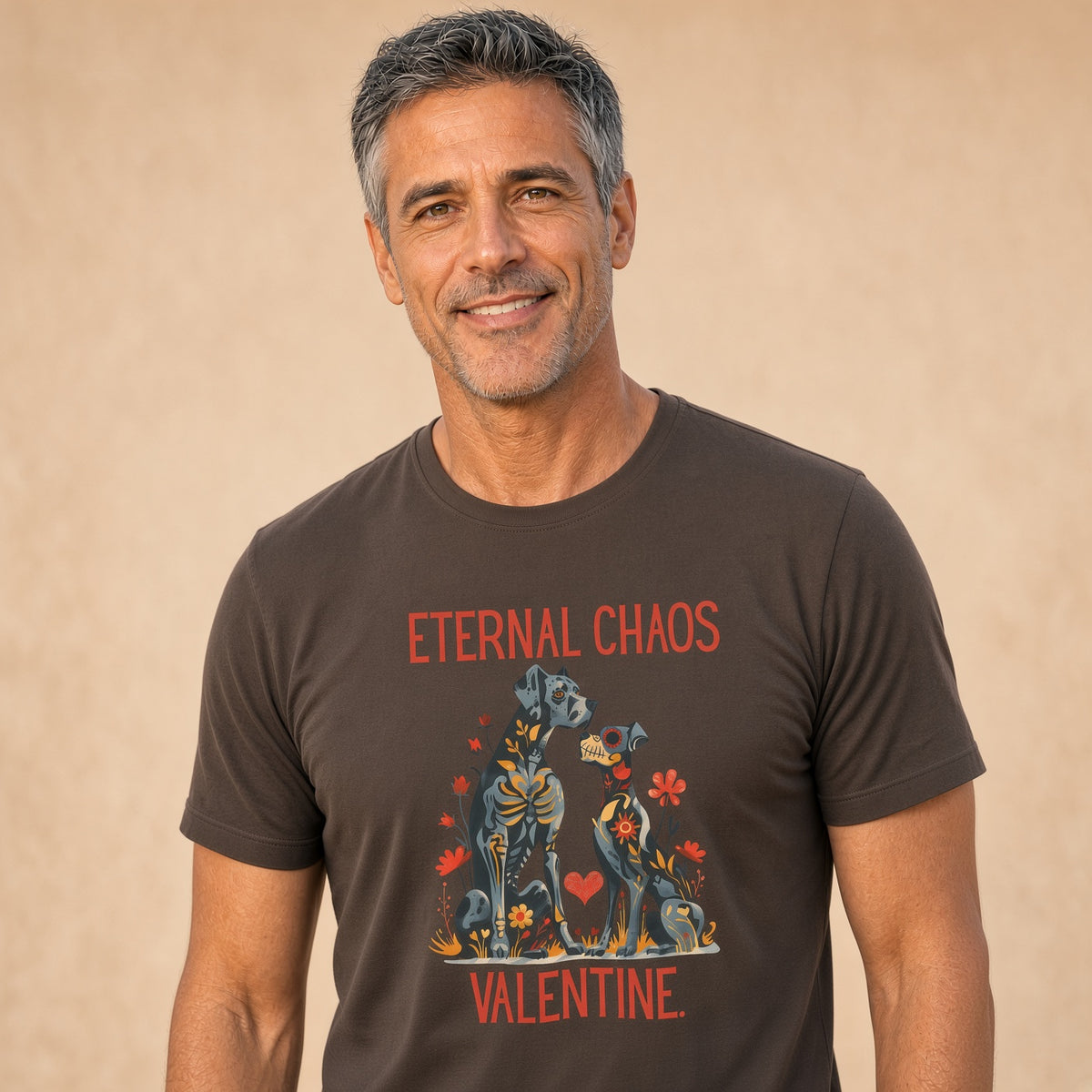 Man smiling while wearing a brown t-shirt with gothic floral dog graphic and text 'ETERNAL CHAOS VALENTINE.'