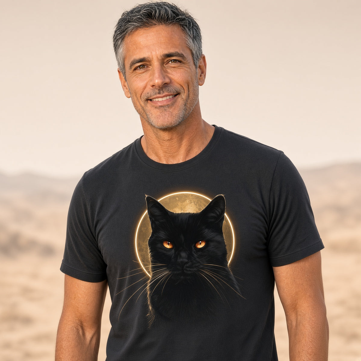 Man wearing a black t-shirt featuring a black cat graphic with glowing eyes and a full moon.