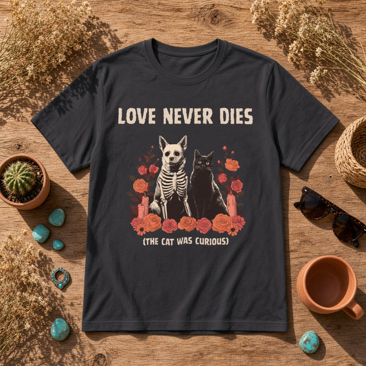 Flat lay of a black t-shirt featuring a skeleton dog and black cat on a wooden surface.