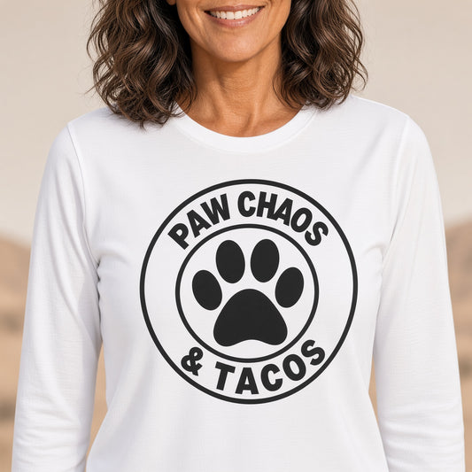 Close-up of a woman wearing a white long sleeve t-shirt with 'Paw Chaos & Tacos' design.