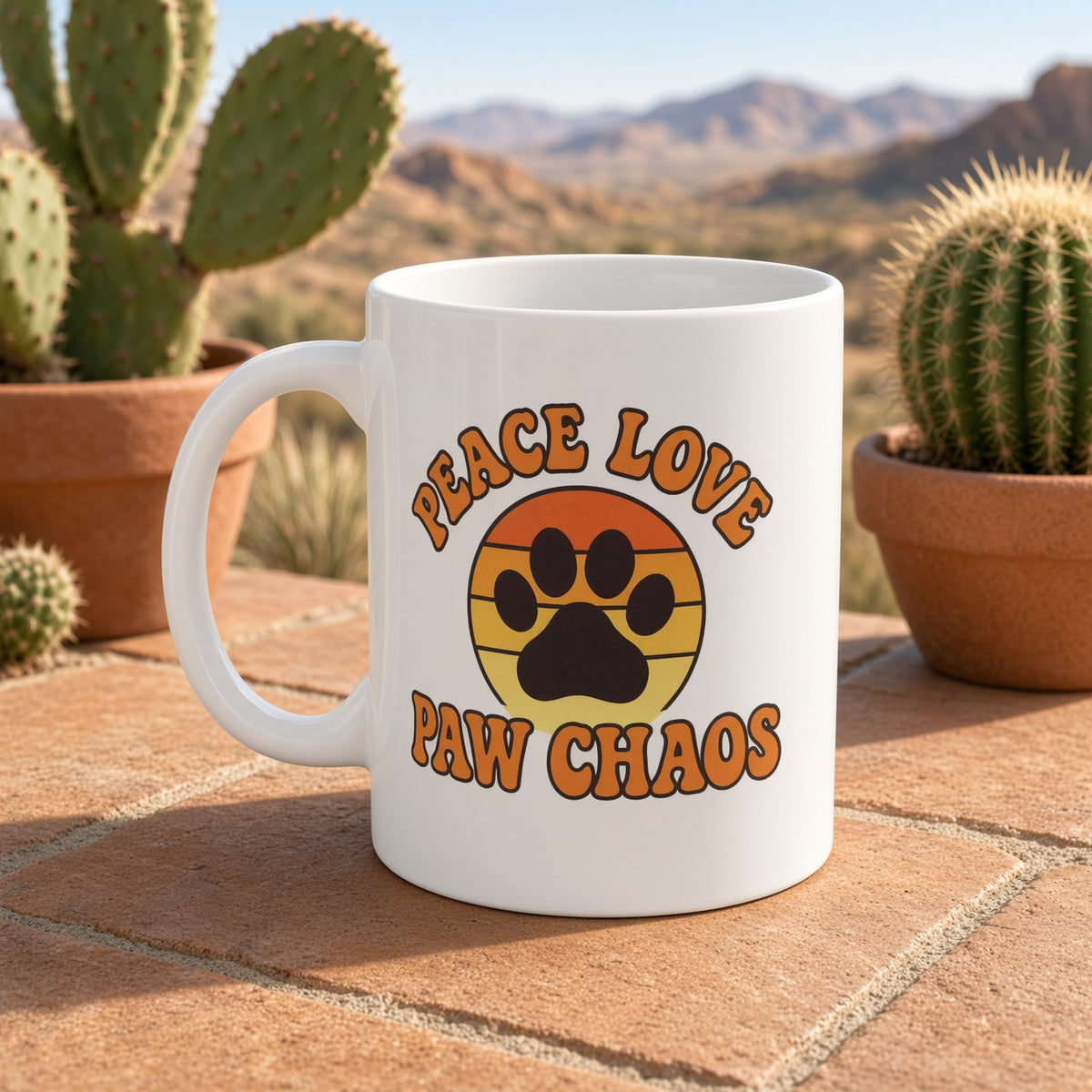 White mug with 'Peace Love Paw Chaos' text and paw print design, set against a desert background.