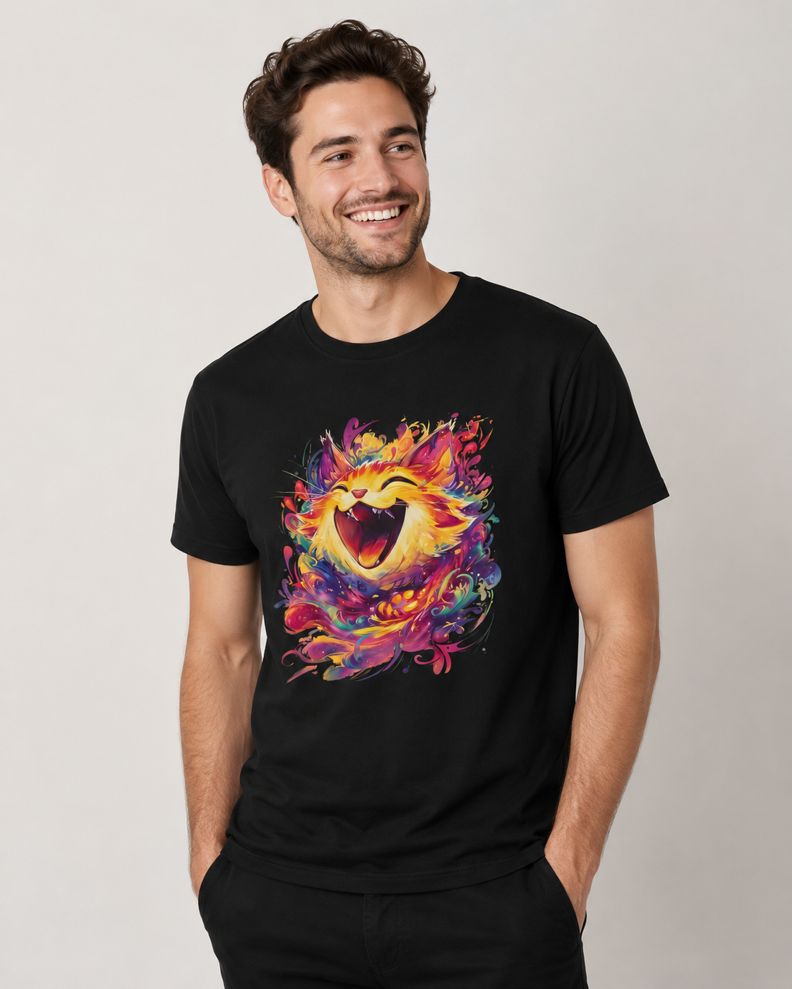 A man wearing a black crew-neck t-shirt with a vibrant, colorful abstract cat graphic print on the front, posed against a neutral light gray background.