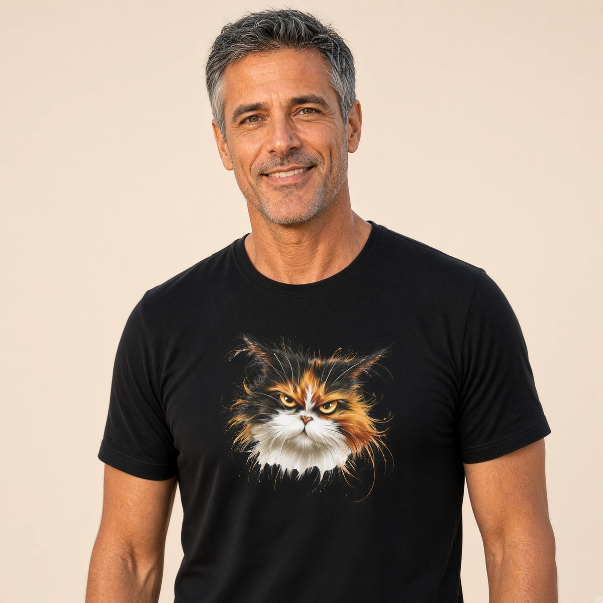 Man smiling in a black t-shirt with a calico cat design on a light background.