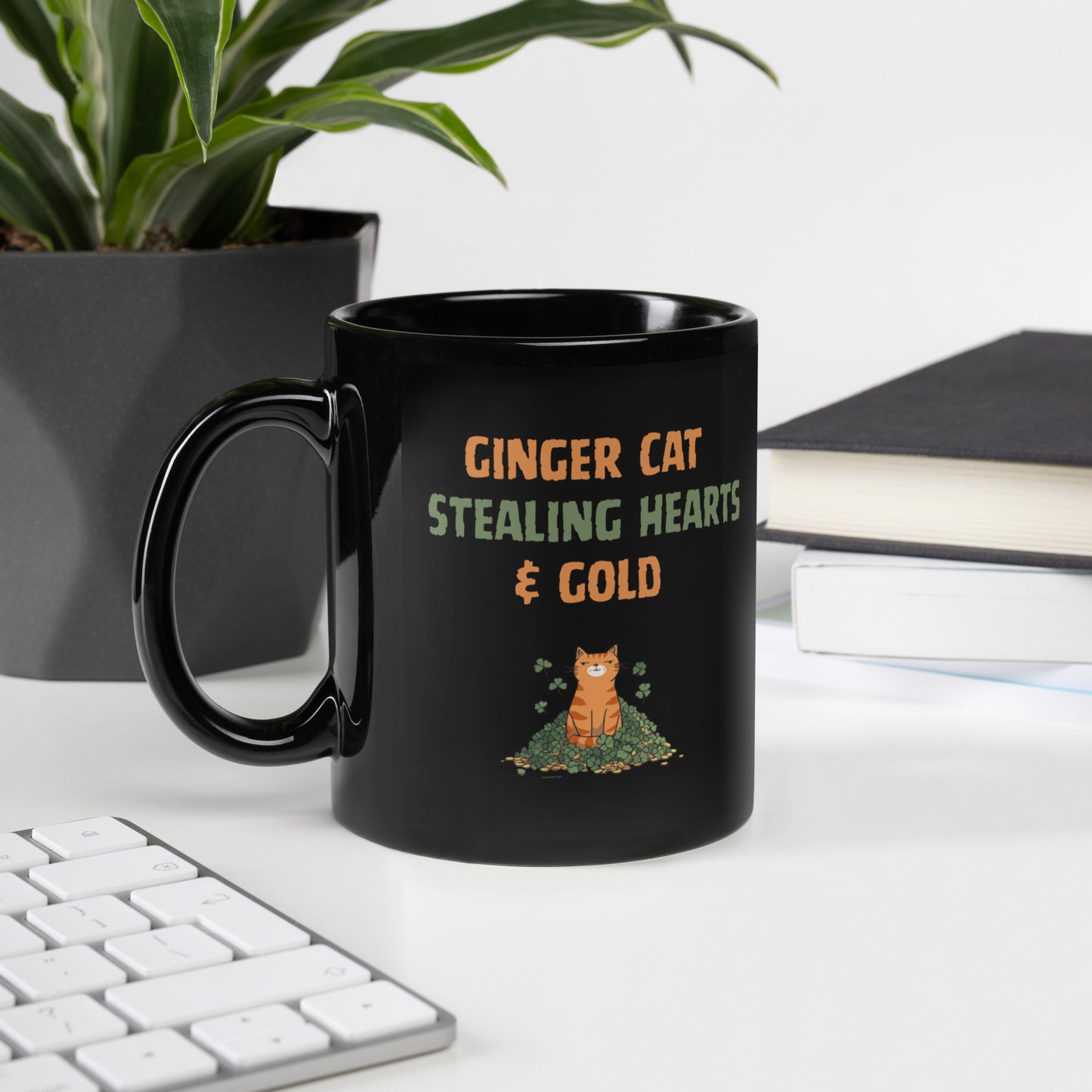Black glossy mug with ‘Ginger Cat Stealing Hearts & Gold’ text and orange tabby sitting on shamrocks and coins.