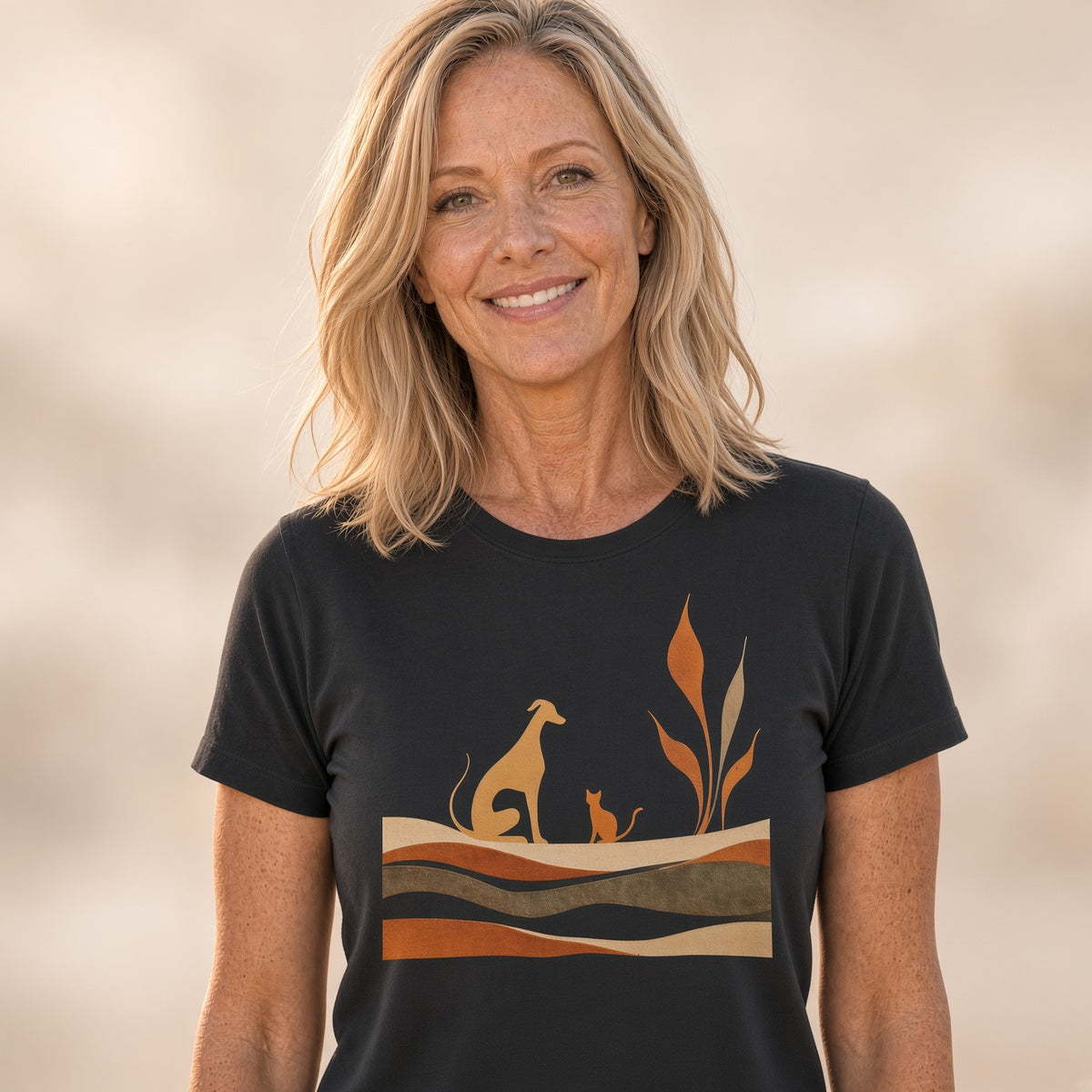 Woman smiling in a black t-shirt featuring a dog and cat silhouette design.