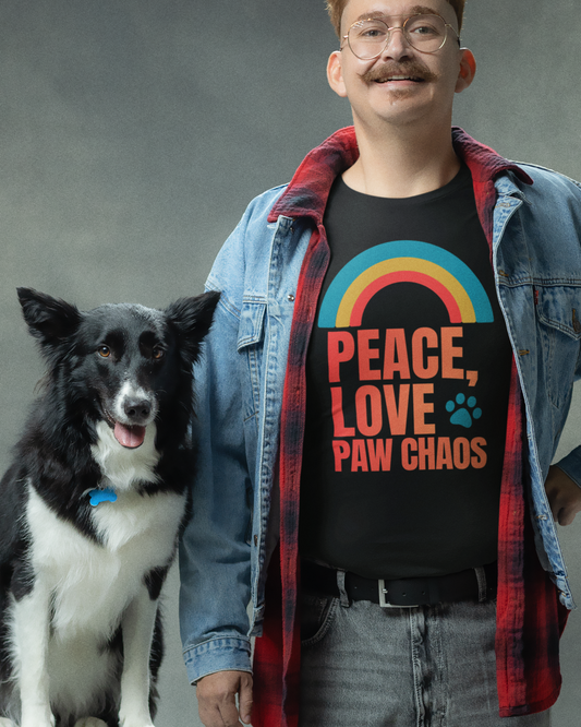 Man wearing a shirt with 'Peace, Love, Paw Chaos' and a dog next to him on a gray background