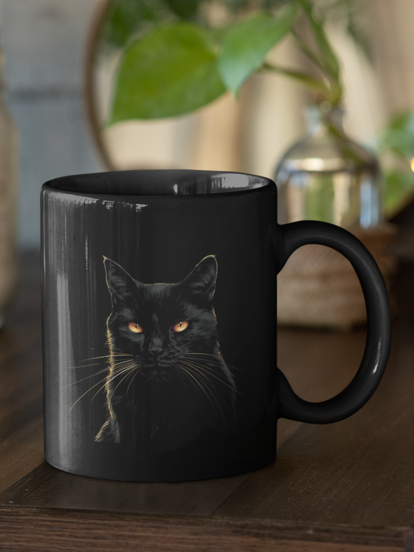 Black mug with a black cat design on a wooden surface